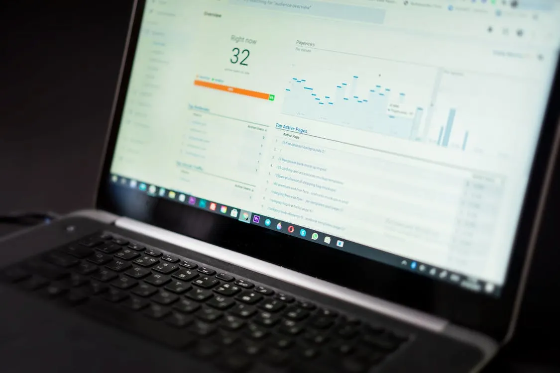 Real-time analytics dashboard on laptop showing live visitor metrics and pageviews